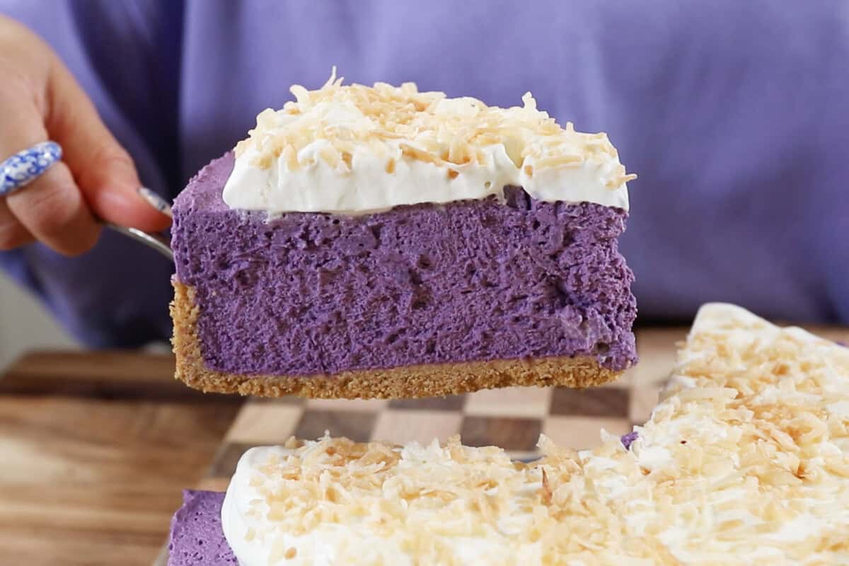 finished ube cheesecake being lifted up