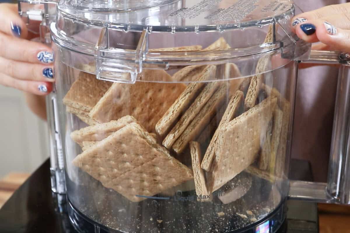 adding graham crackers to the food processor