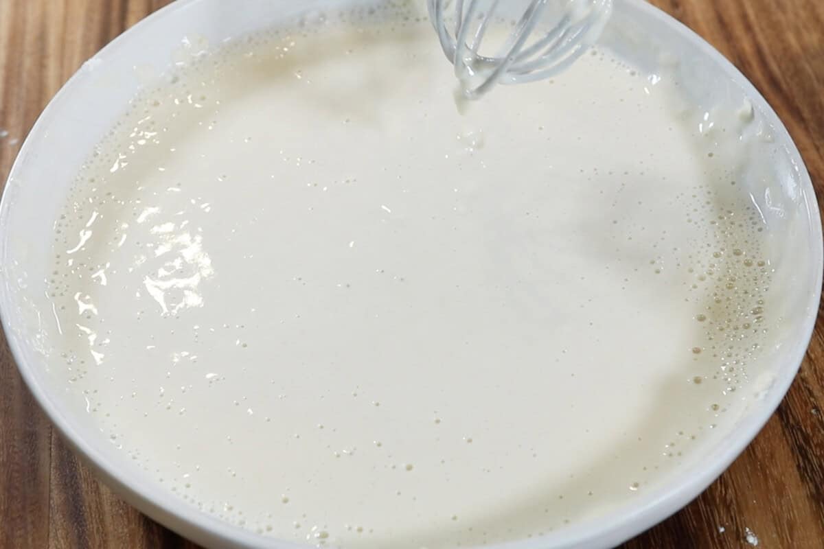 mixing wet batter in a wide and shallow bowl