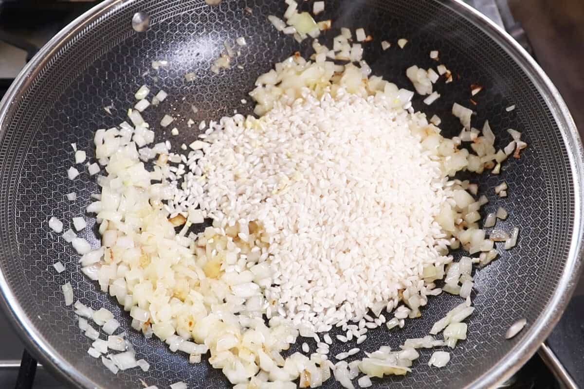 adding rice to sautéd onions