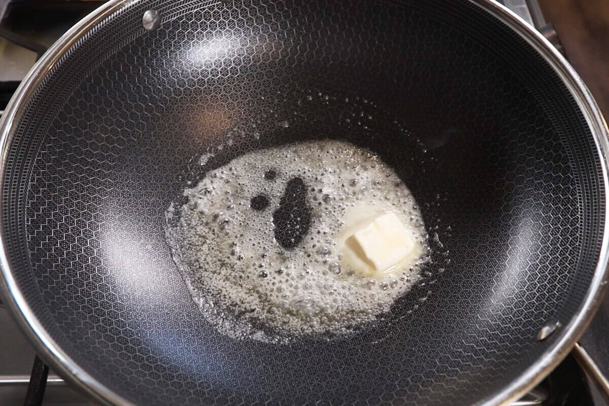 melted butter in a large wok