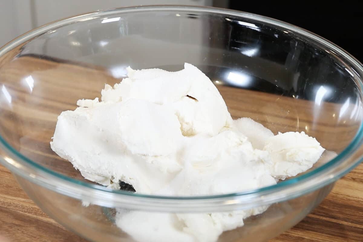 vegan cream cheese and sugar in large glass bowl