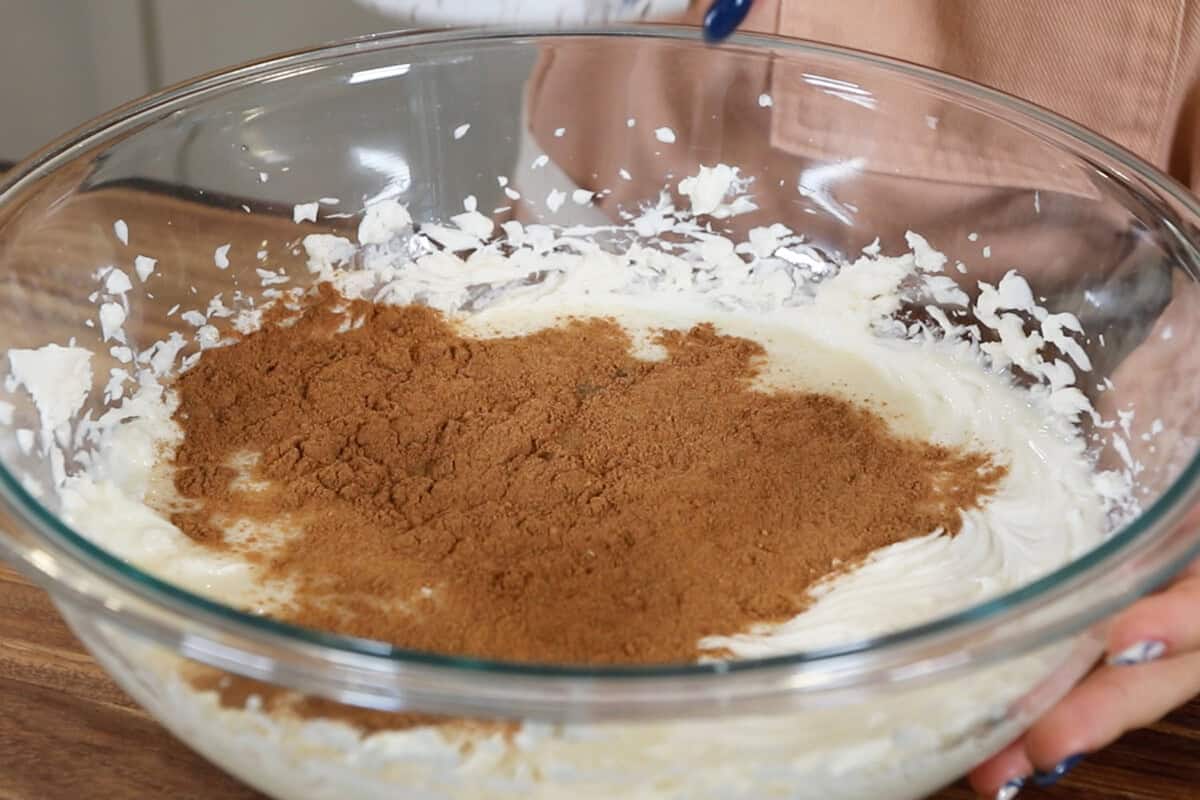 preparing vegan chai spiced cheesecake filling in large glass bowl