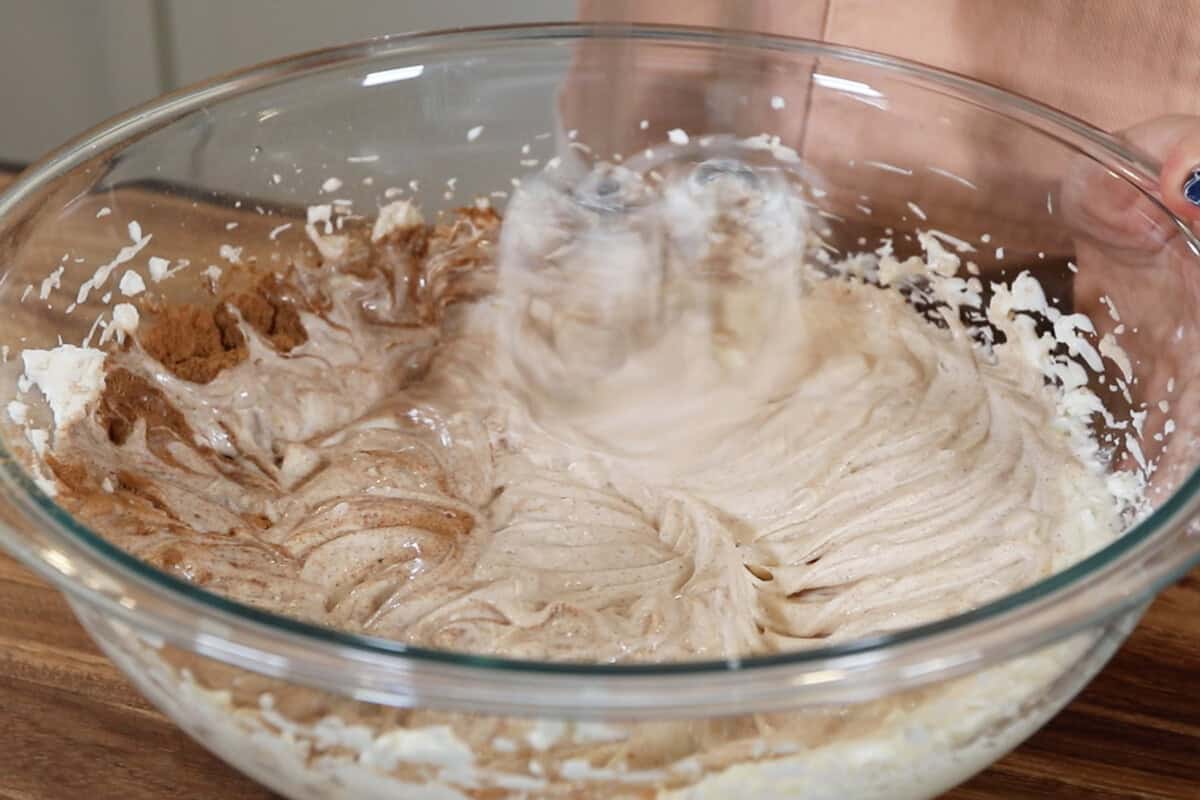 preparing vegan chai spiced cheesecake filling in large glass bowl