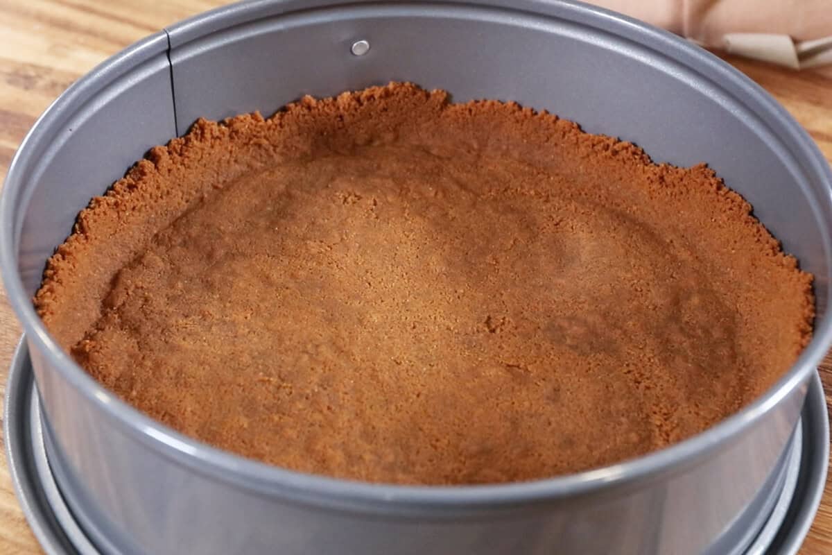 homemade biscoff crust in pan for cheesecake