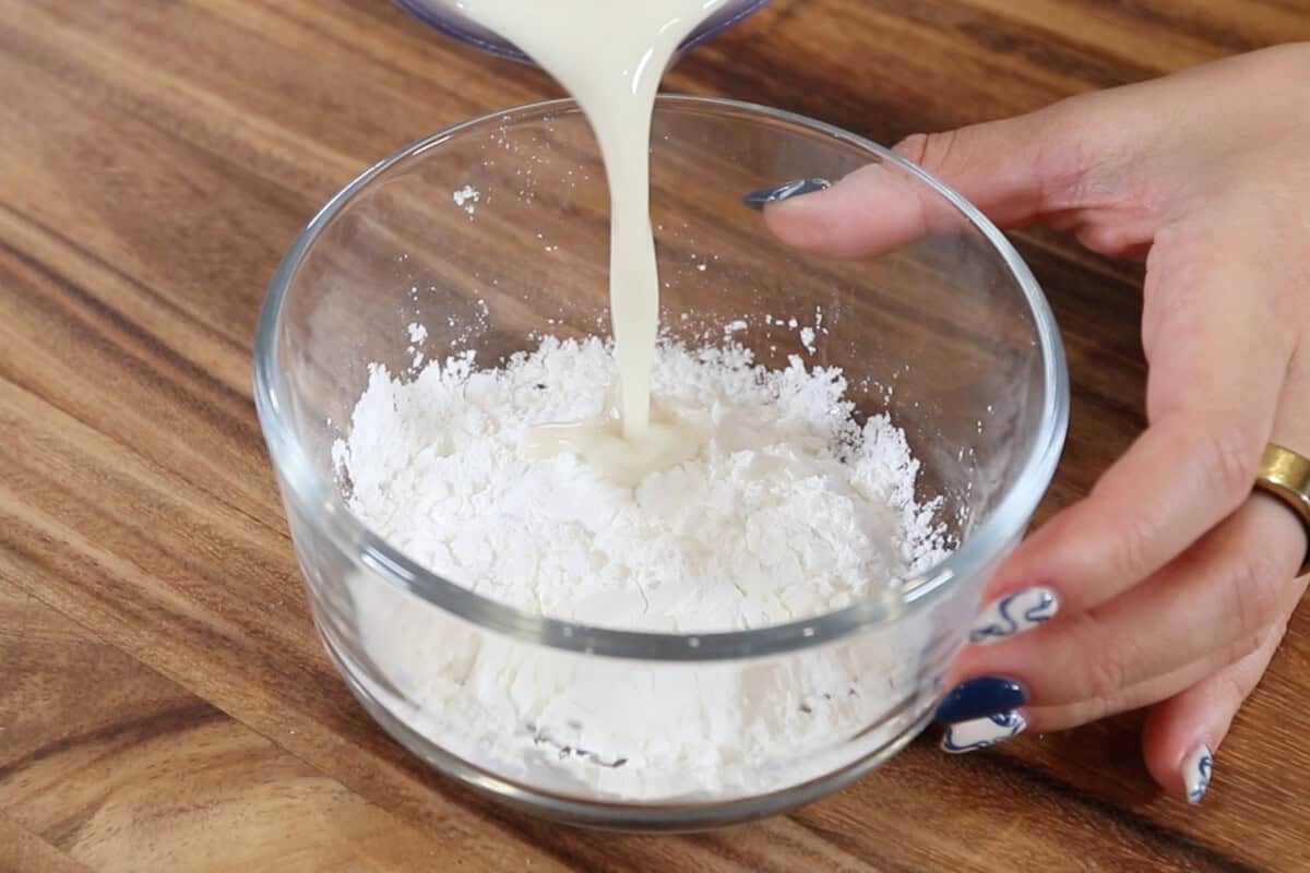 preparing a cornstarch slurry in a small glass bowl