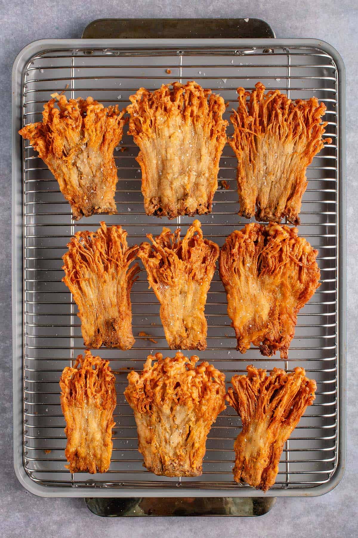 fried enoki mushrooms on cooling rack