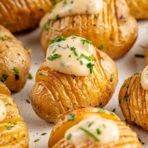 vegan sour cream and onion hasselback potatoes on plate
