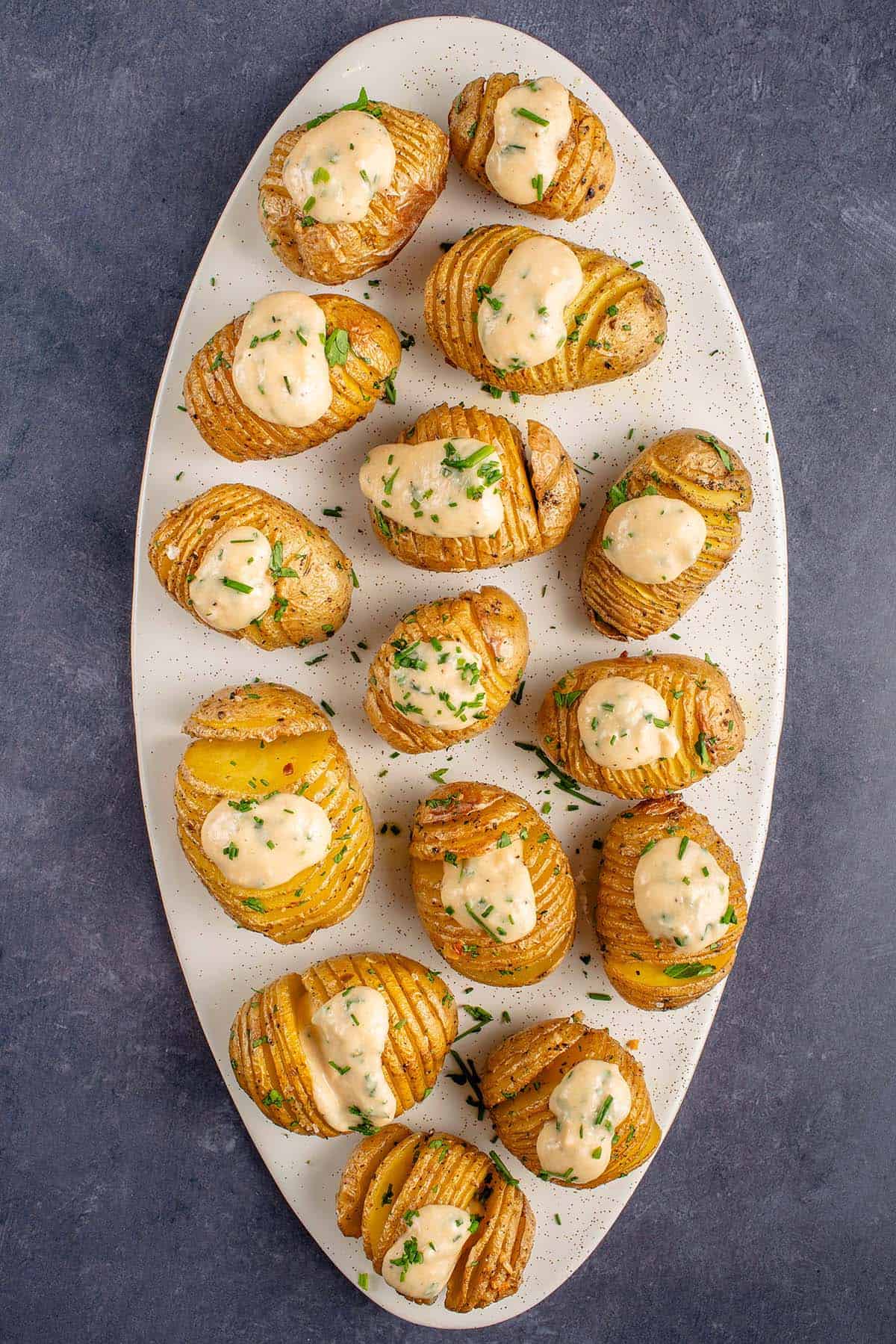 overhead of sour cream and onion hasselback potatoes on tray