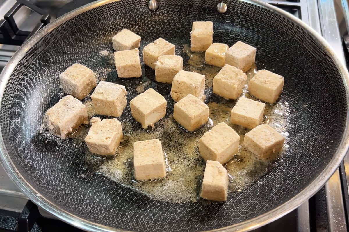 pan frying tofu in skillet