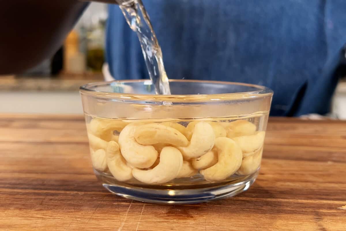 soaking cashews in container with hot water