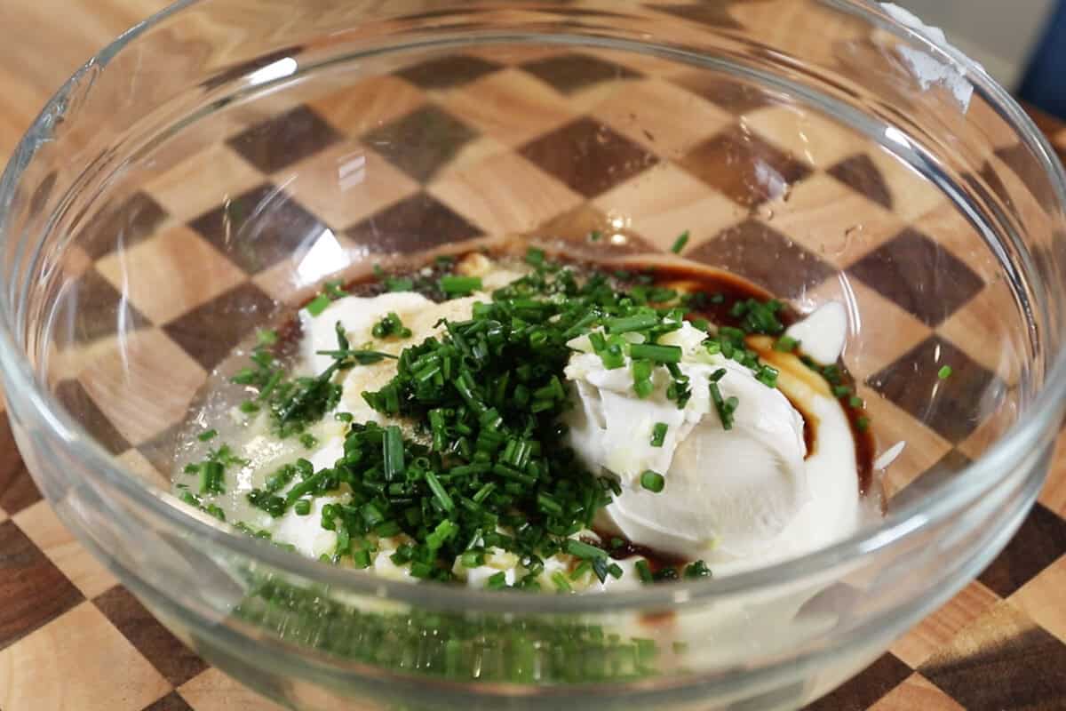 ingredients for sour cream and onion dip in a bowl