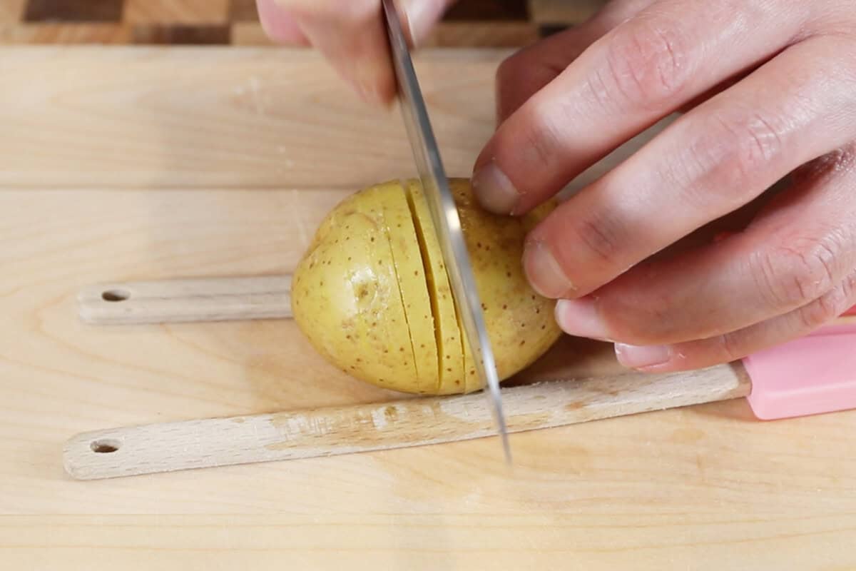 thinly slicing potatoes