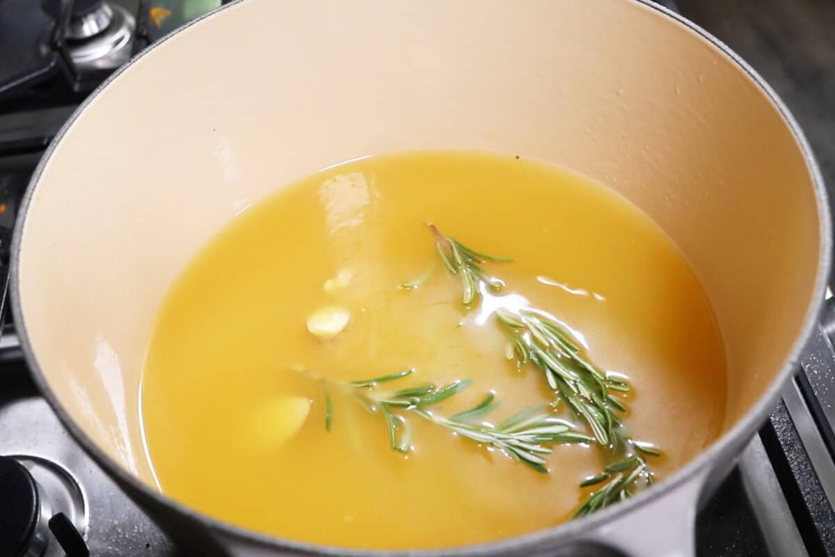 adding garlic and thyme to pot