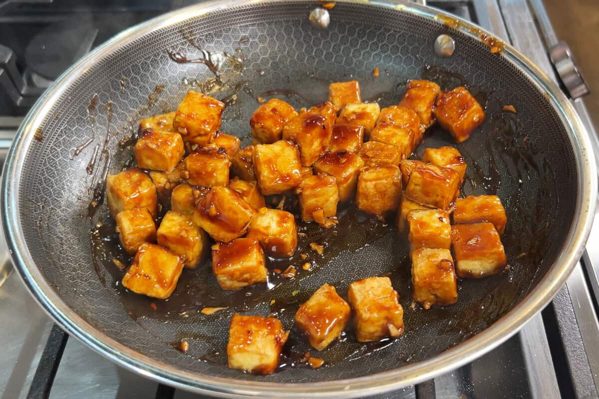 coated tofu in a skillet