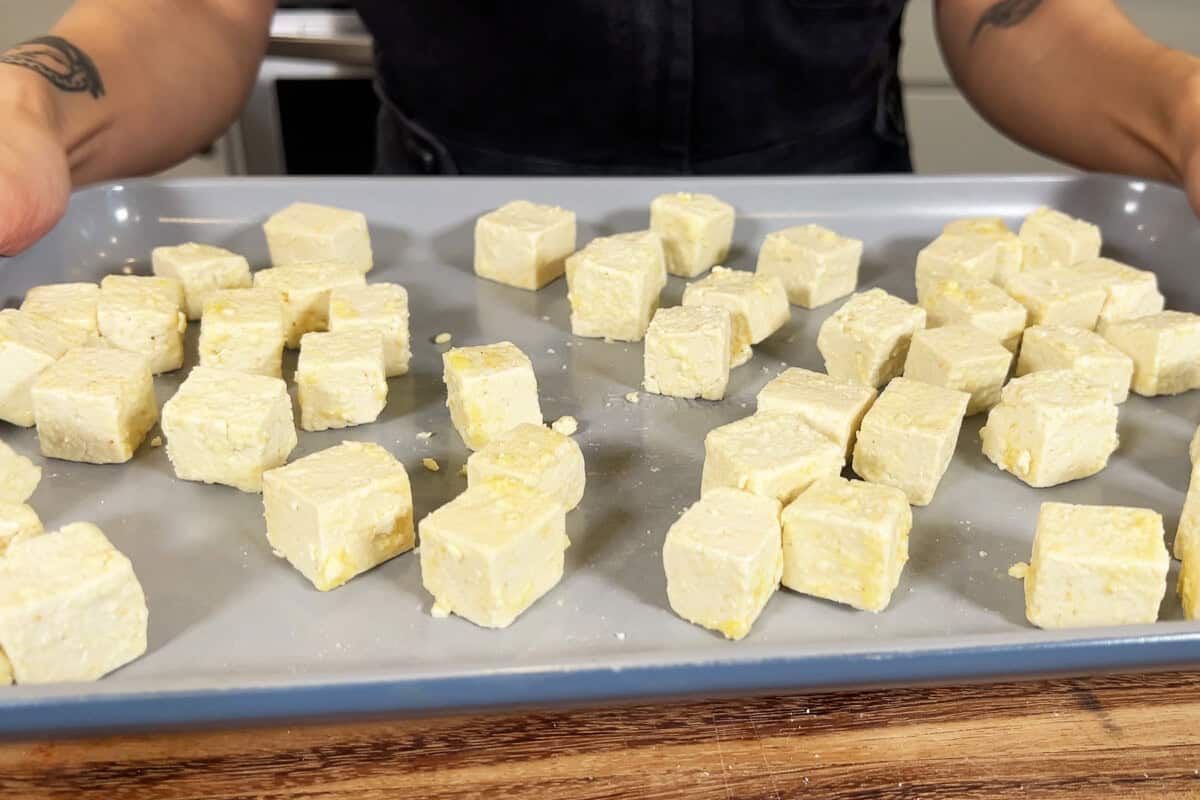 coated tofu cubes on baking sheet