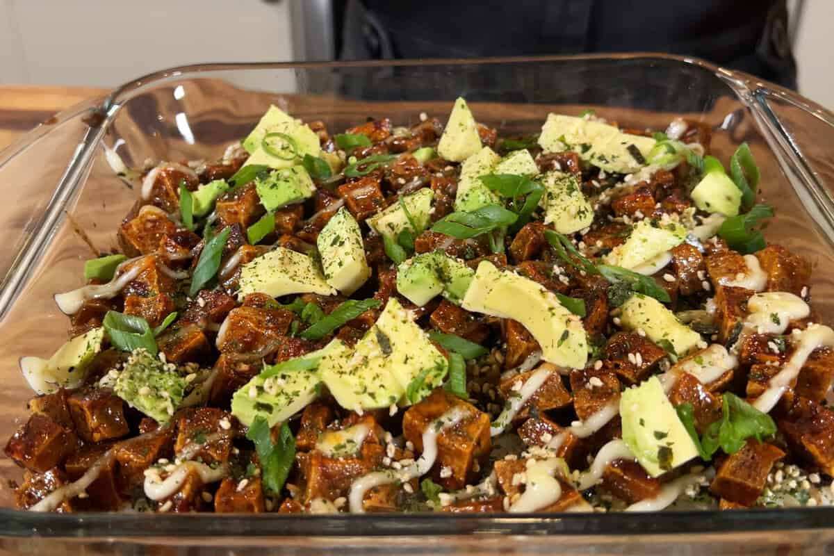 musubi bake topped with avocado and green onions