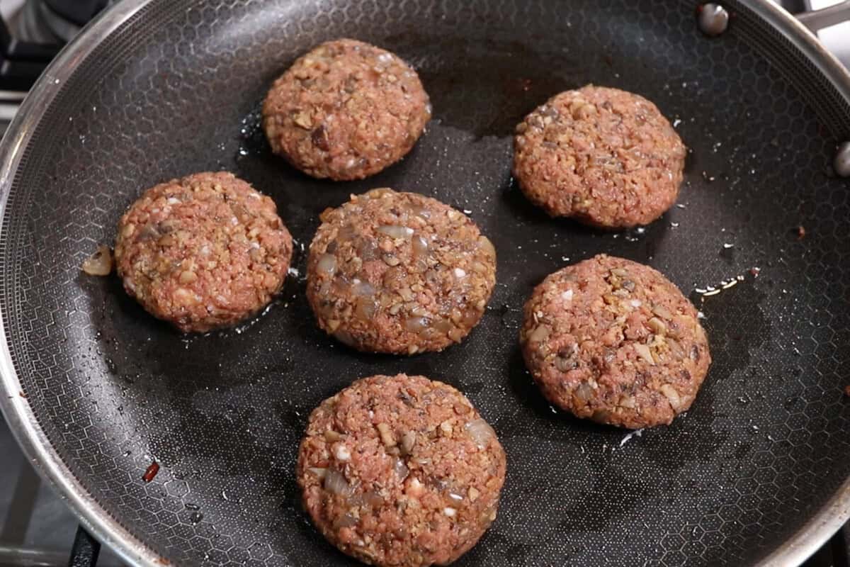 pan frying burger steak patties in skillet