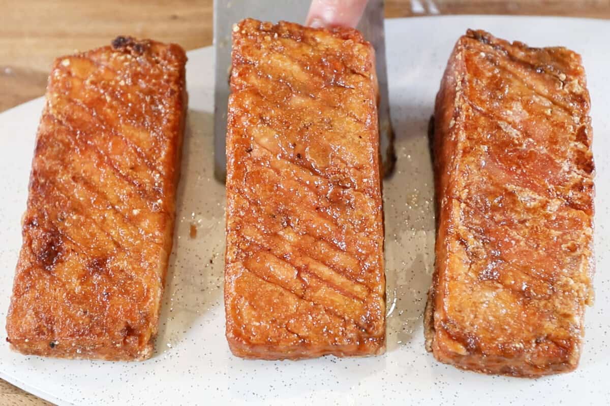 finished tofu salmon being placed on a white plate