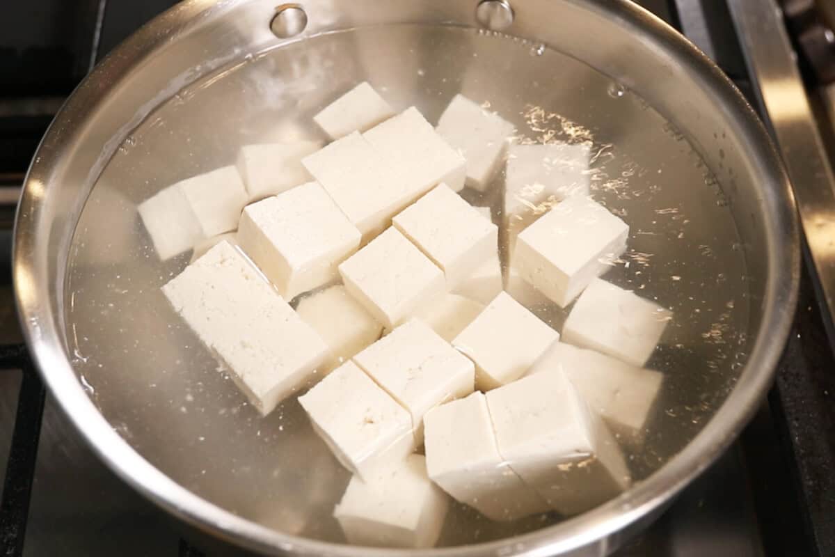 adding tofu to salted boiling water