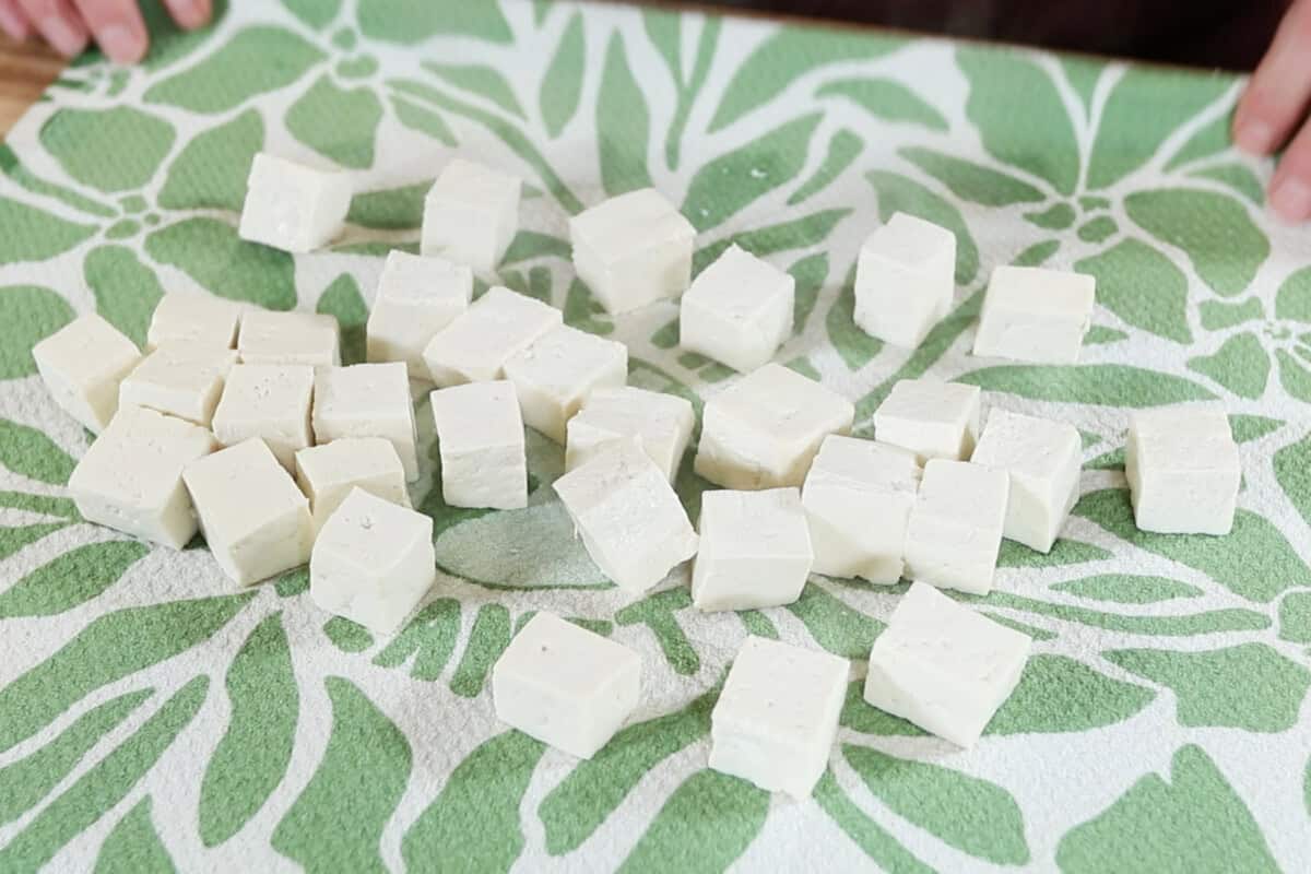 patting dry the boiled tofu