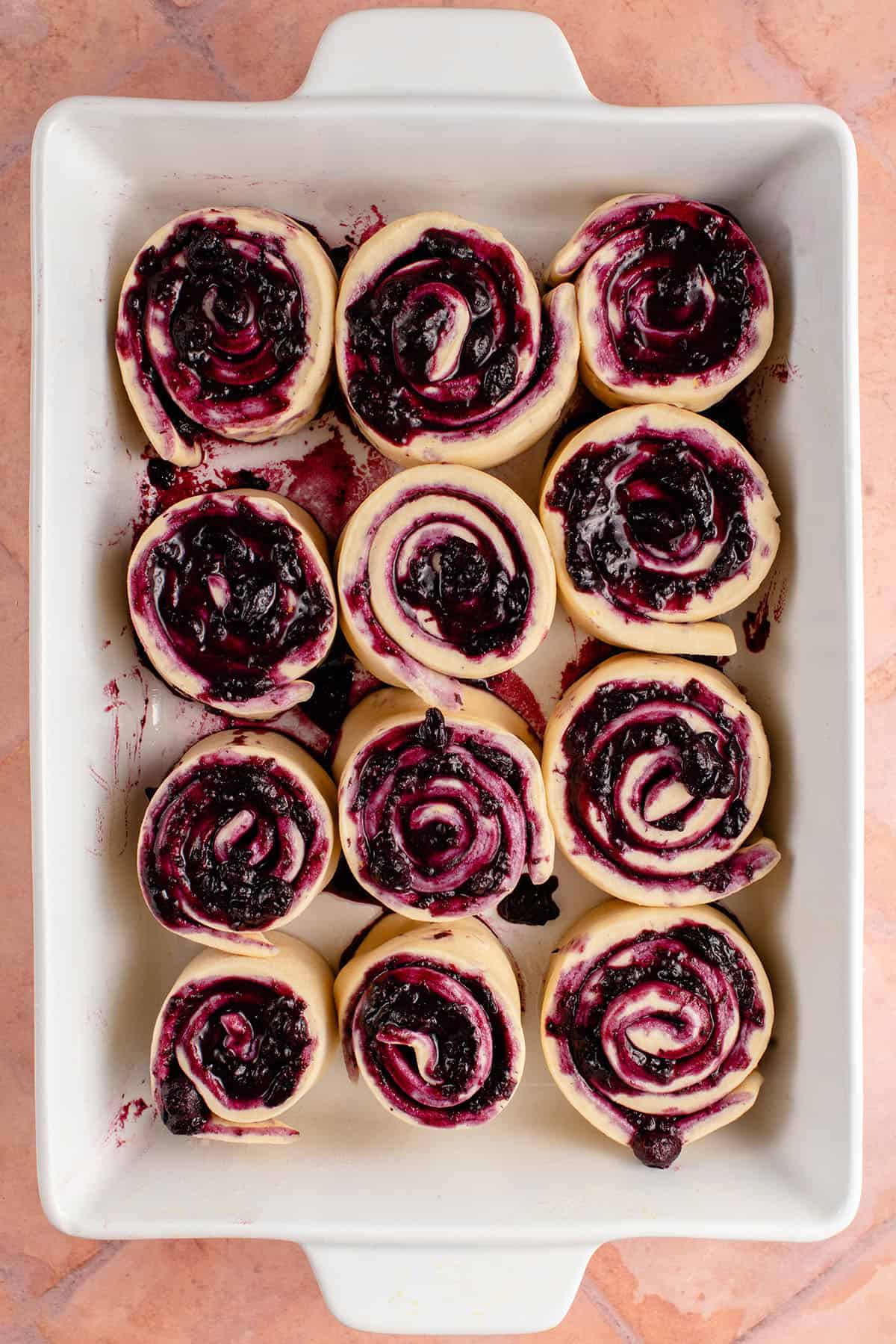 overhead photo of a tray of lemon blueberry rolls before rising