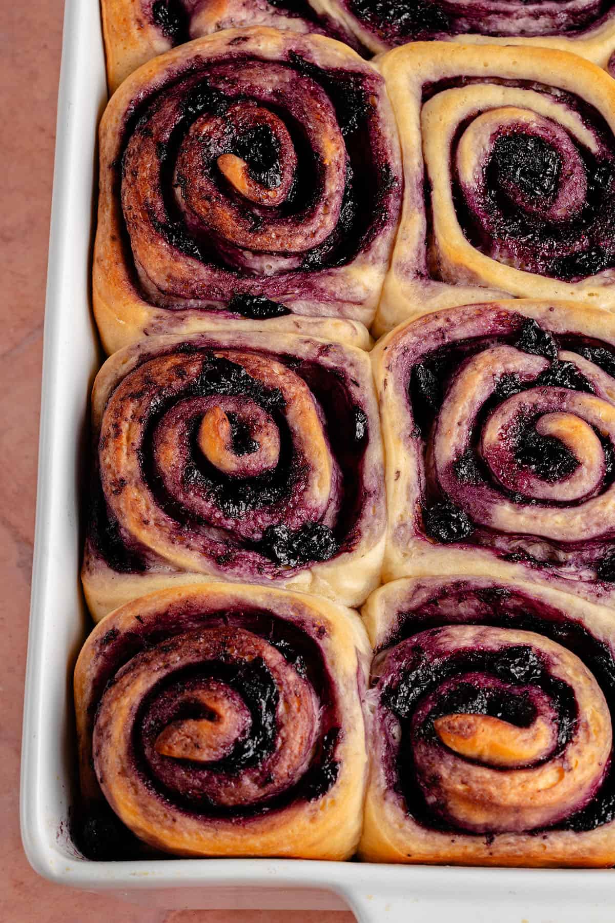 overhead photo of a tray of lemon blueberry rolls after baking