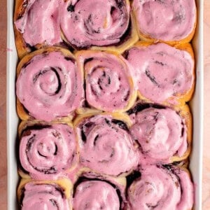 overhead photo of a tray of lemon blueberry rolls with blueberry cream cheese frosting