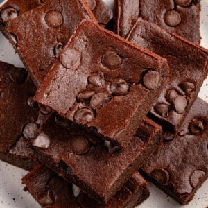 overhead of vegan mochi brownies stacked on white plate