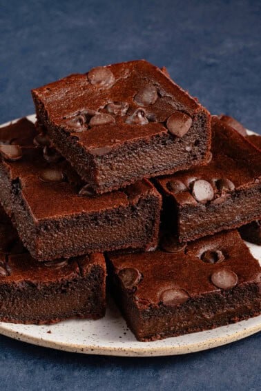 vegan mochi brownies stacked on plate