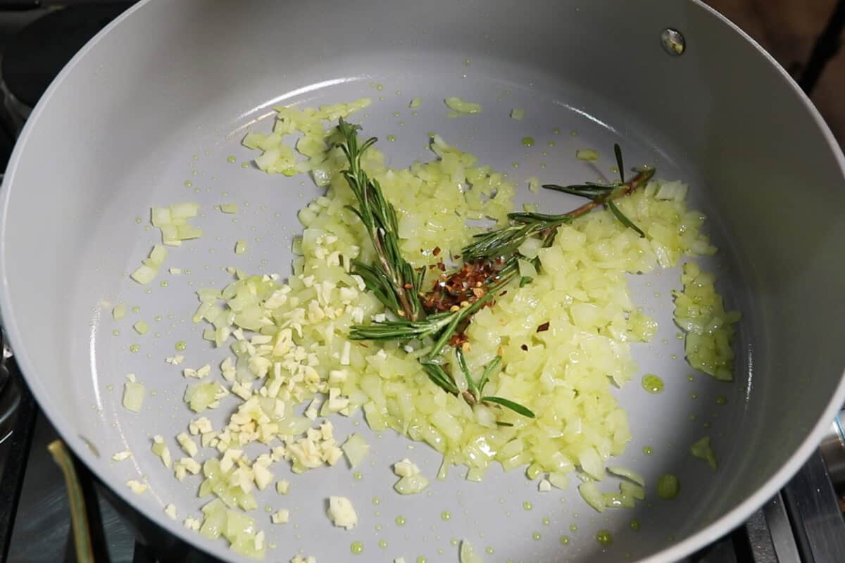 cooking onion, garlic, rosemary, and red pepper flakes with oil in a dutch oven