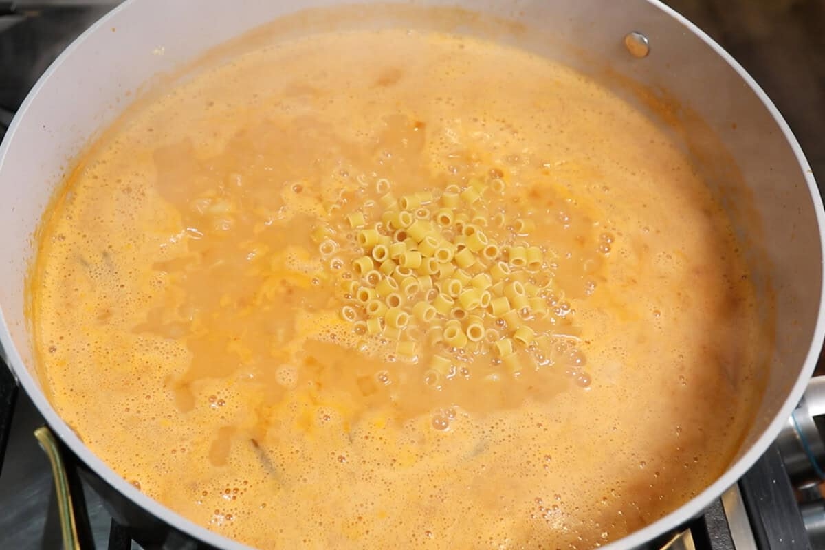adding pasta to the dutch oven