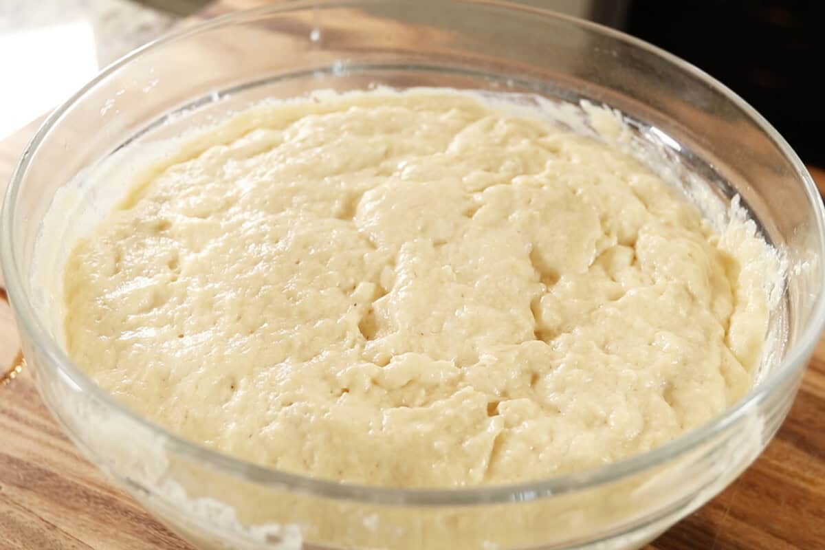 making dough for Vegan Lemon Blueberry Sweet Rolls in large glass bowl