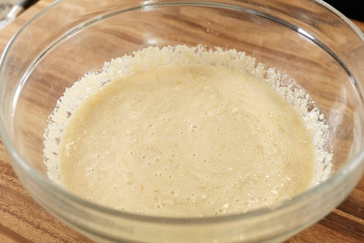 making dough for Vegan Lemon Blueberry Sweet Rolls in large glass bowl