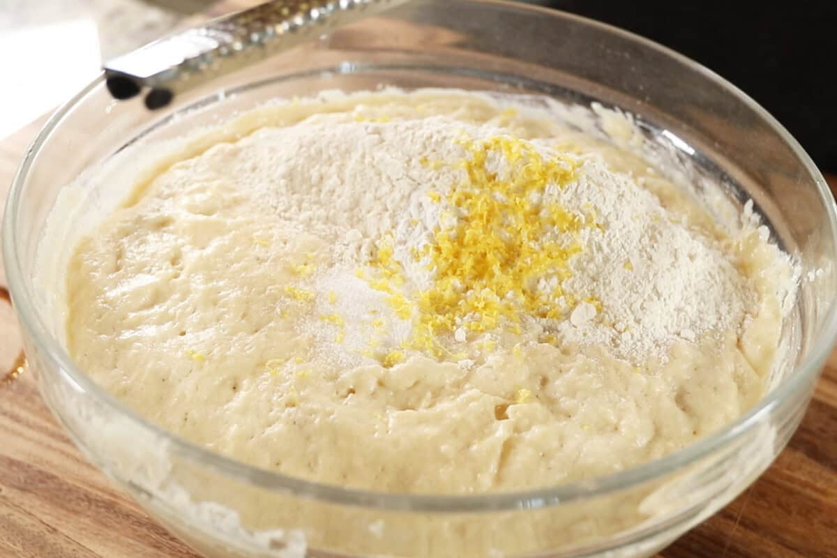 making dough for Vegan Lemon Blueberry Sweet Rolls in large glass bowl