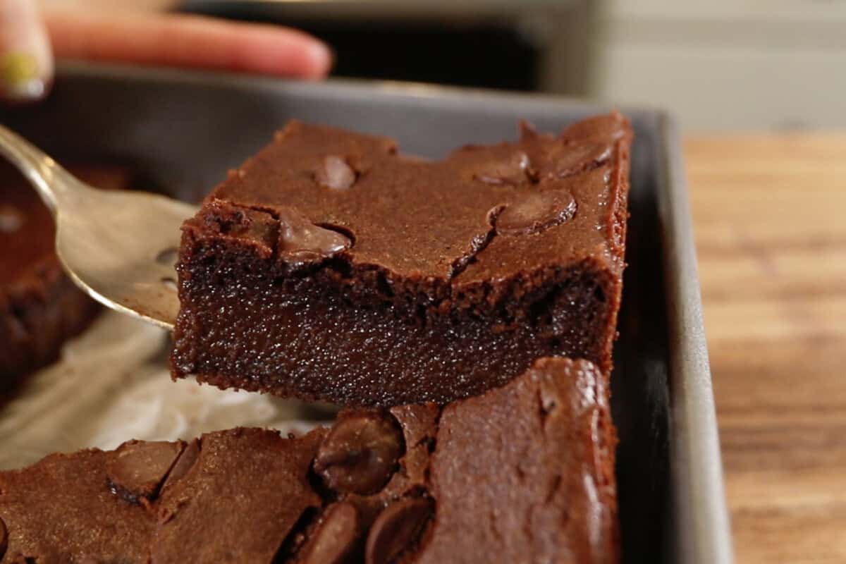 lifting finished brownies out of the tray
