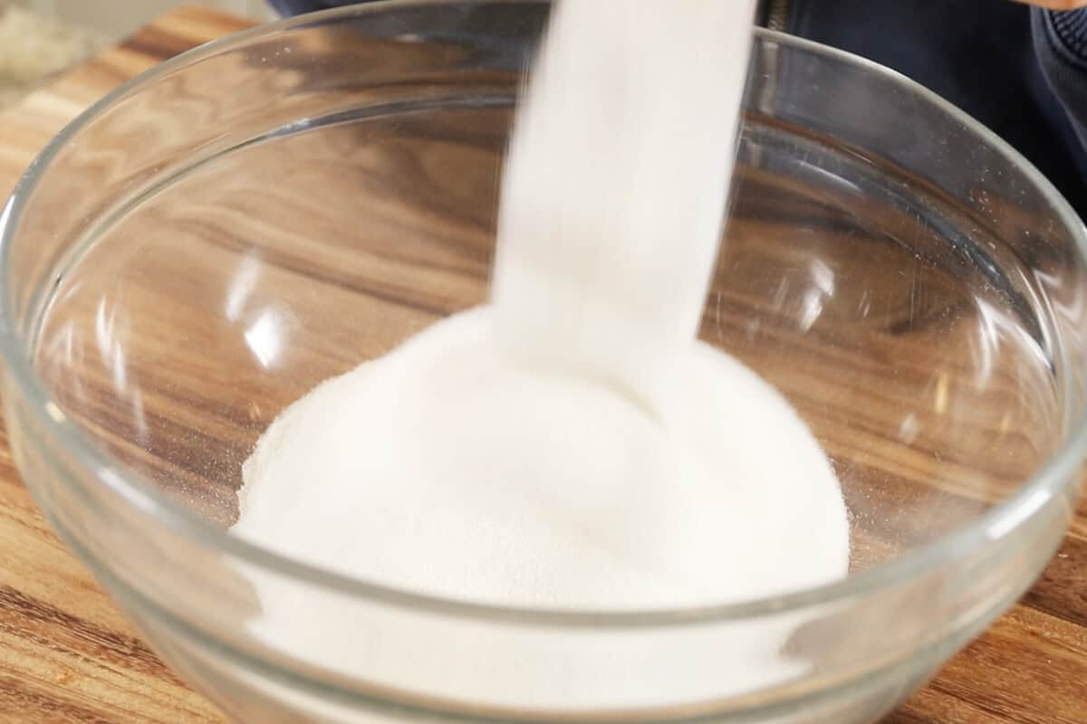 adding sugar to the bowl