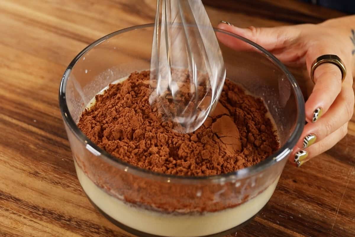 whisking in cocoa powder