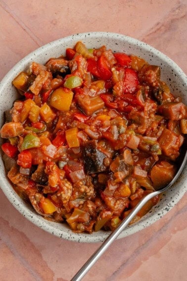 white bowl of Eggplant Caponata with spoon