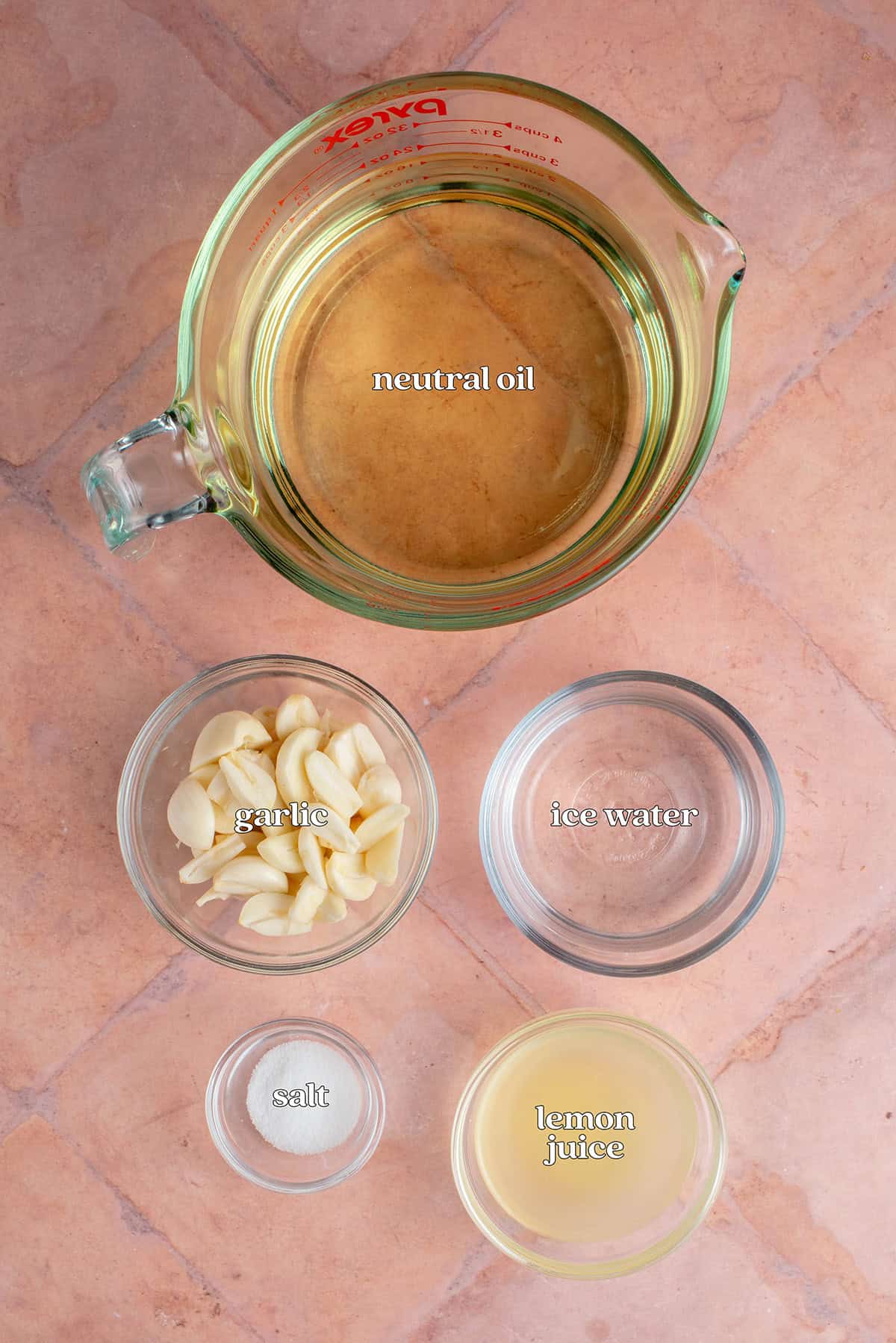 labeled ingredients for Lebanese Garlic Sauce (Toum): neutral oil, garlic, ice water, salt and lemon juice