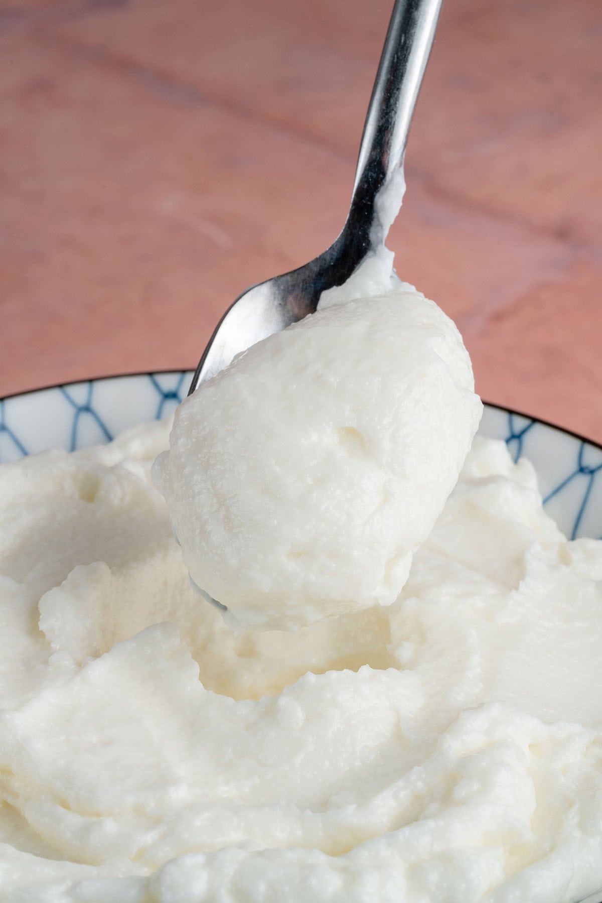scooping bfresh Lebanese Garlic Sauce (Toum) with spoon