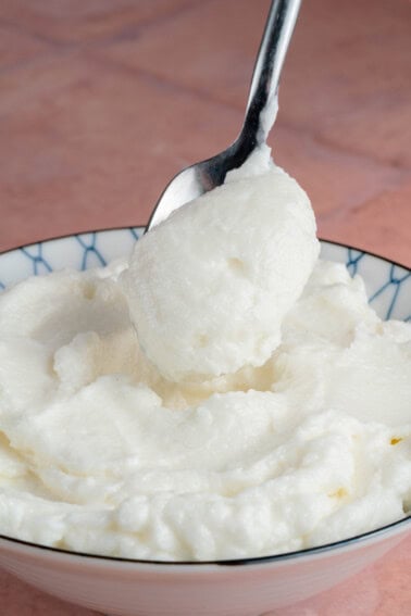 scooping bfresh Lebanese Garlic Sauce (Toum) with spoon