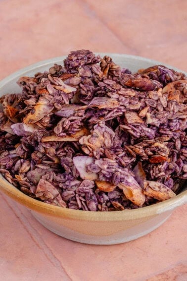 Bowl filled with crunchy Ube Coconut Granola