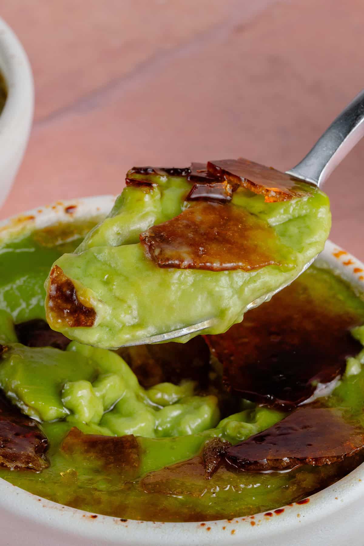 close up photo of a spoon full of Vegan Matcha Crème Brûlée