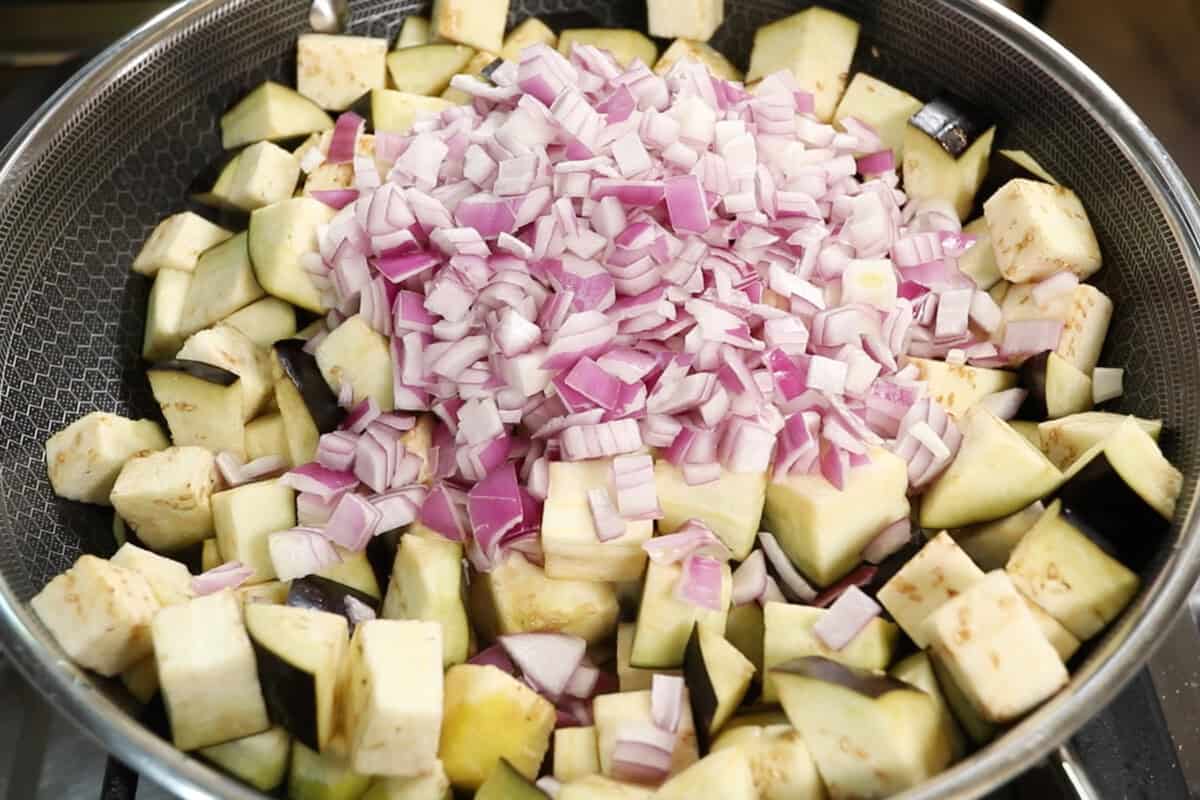preparing Eggplant Caponata in a large wok