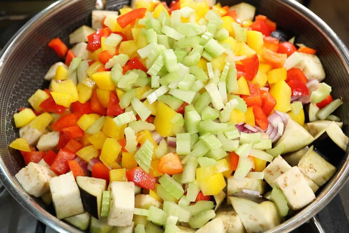preparing Eggplant Caponata in a large wok