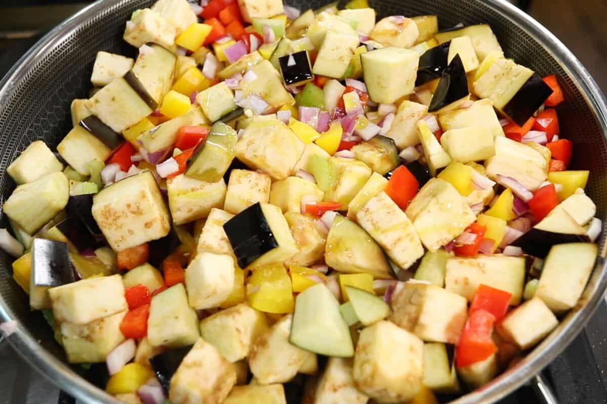 preparing Eggplant Caponata in a large wok