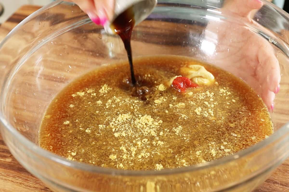 making marinade for Ham-Style Tofu Deli Meat Slices in large glass bowl