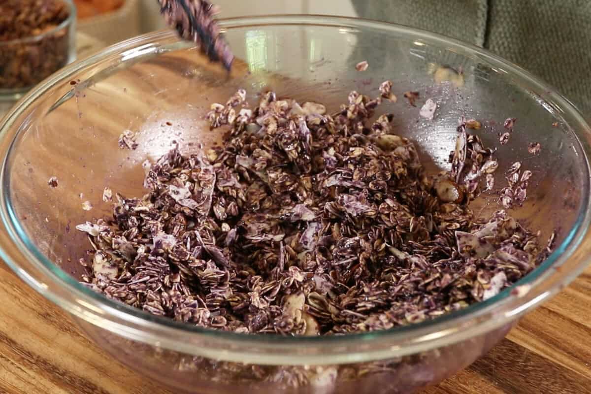 making Ube Coconut Granola in large glass bowl