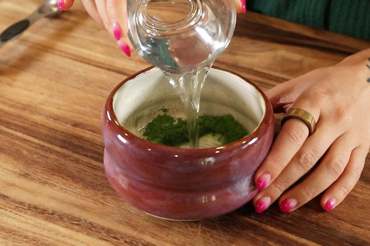pouring hot water into matcha powder